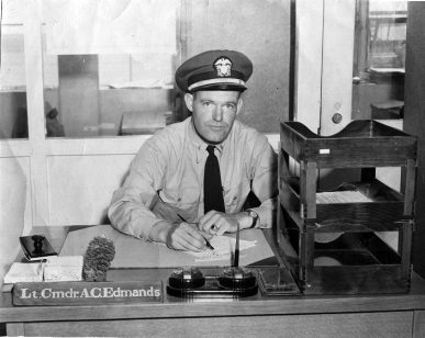 [ Lt. Cmdr. Allan C. Edmands at his desk ]